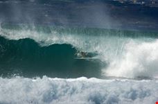 las palmas de gran canaria surfer deep in the barrel of a wave