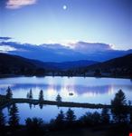 Mountain moonset over lake