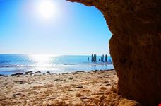 Historic ruined jetty from a cliffside cave