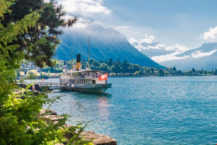 Sulle rive di un lago ai piedi delle Alpi c'è un borgo dall'atmosfera davvero unica: sembra che il suo castello galleggi sull'acqua | PaesiOnLine