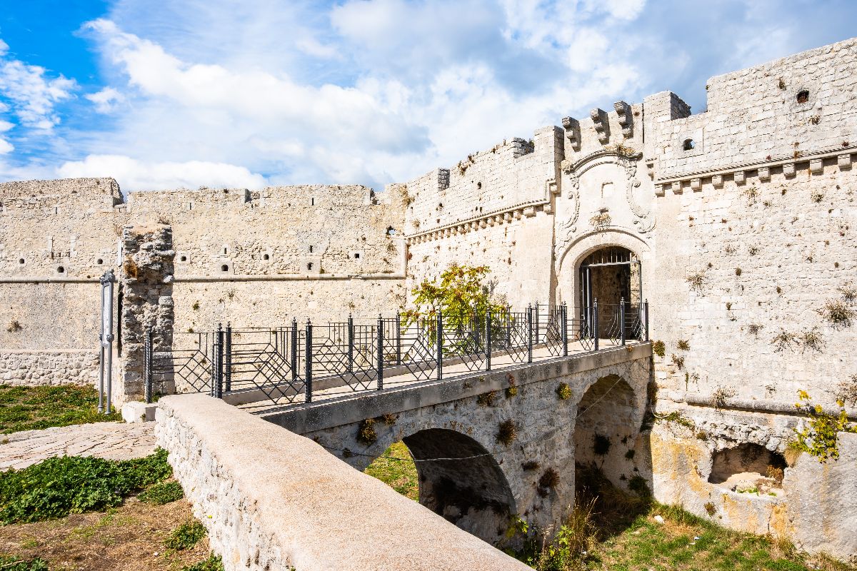 In Puglia esiste una città bianca sospesa tra cielo e mare: la sua grotta sacra attira pellegrini da tutto il mondo